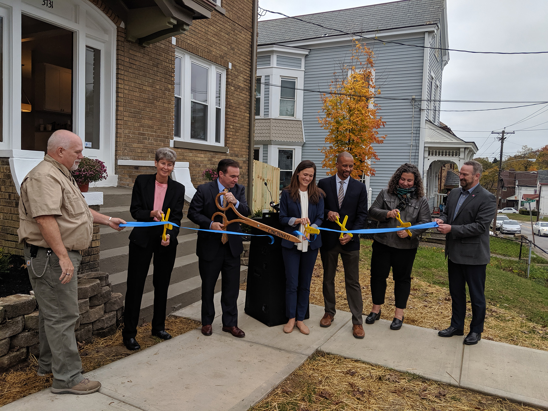Photo of official ribbon cutting in front of Price Hill home on St. Lawrence Avenue. neighborhood revitalization